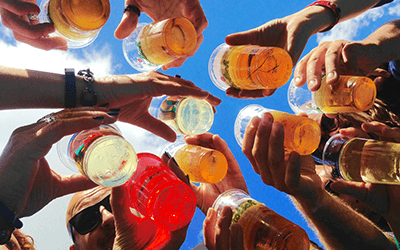 A group raising a cup of beer to celebrate