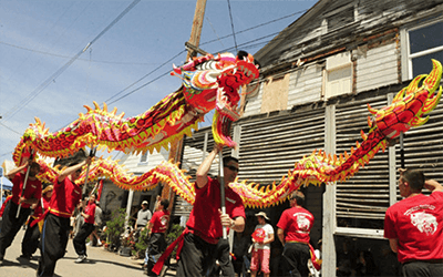 Dragon dancers holding up a dragon puppet to perform
