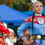People celebrating Native American culture in cultural clothing