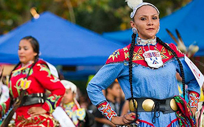 People celebrating Native American culture in cultural clothing