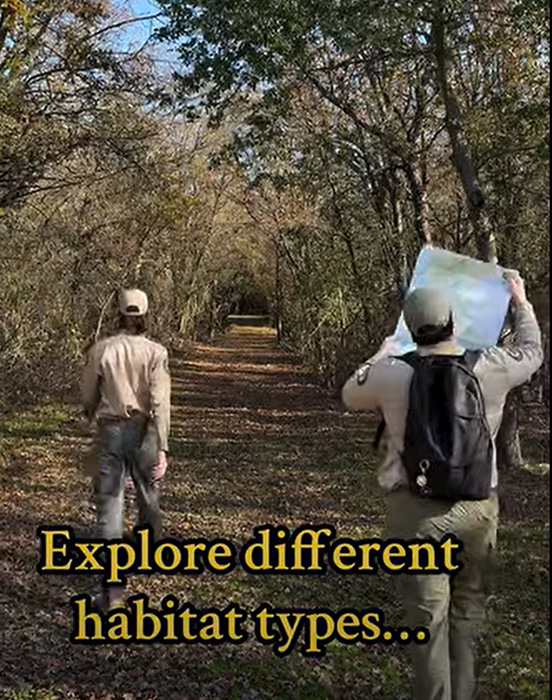 Hikers on a trail, one holding a map